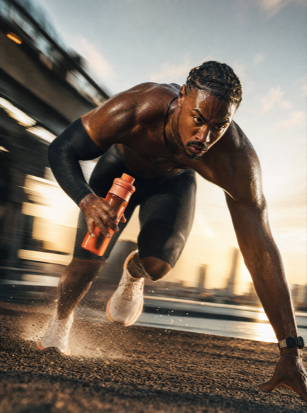 Runner holding an activated charcoal bottle at a starting line